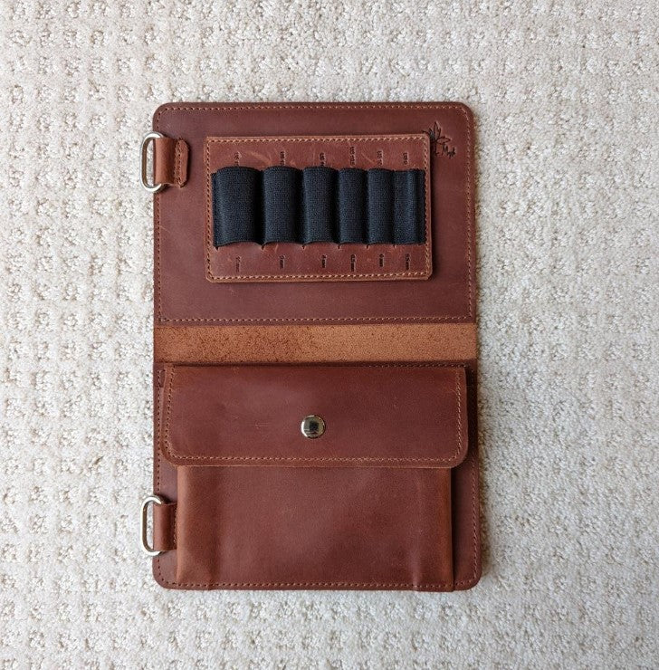 Whiskey colored leather knitting needle case open showing slots and notions pocket 