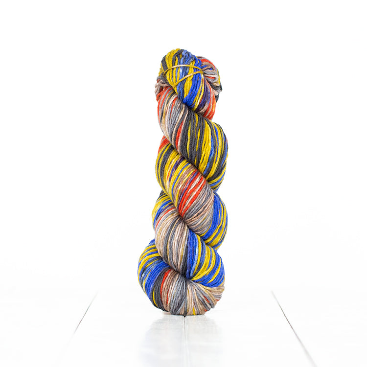 Color 6015, hand-dyed yarn in self-striping primary blue, yellow, & red with soft neutrals.