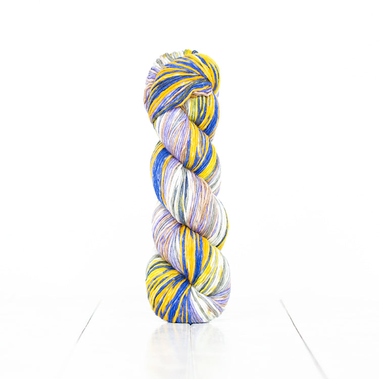 Color 6016, hand-dyed self-striping yarn in blue & yellow with soft greens, purple, and white.