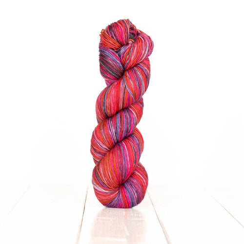 Color 3005: a hand-dyed self-striping wool yarn with pink, red, purple, and brown stripes.