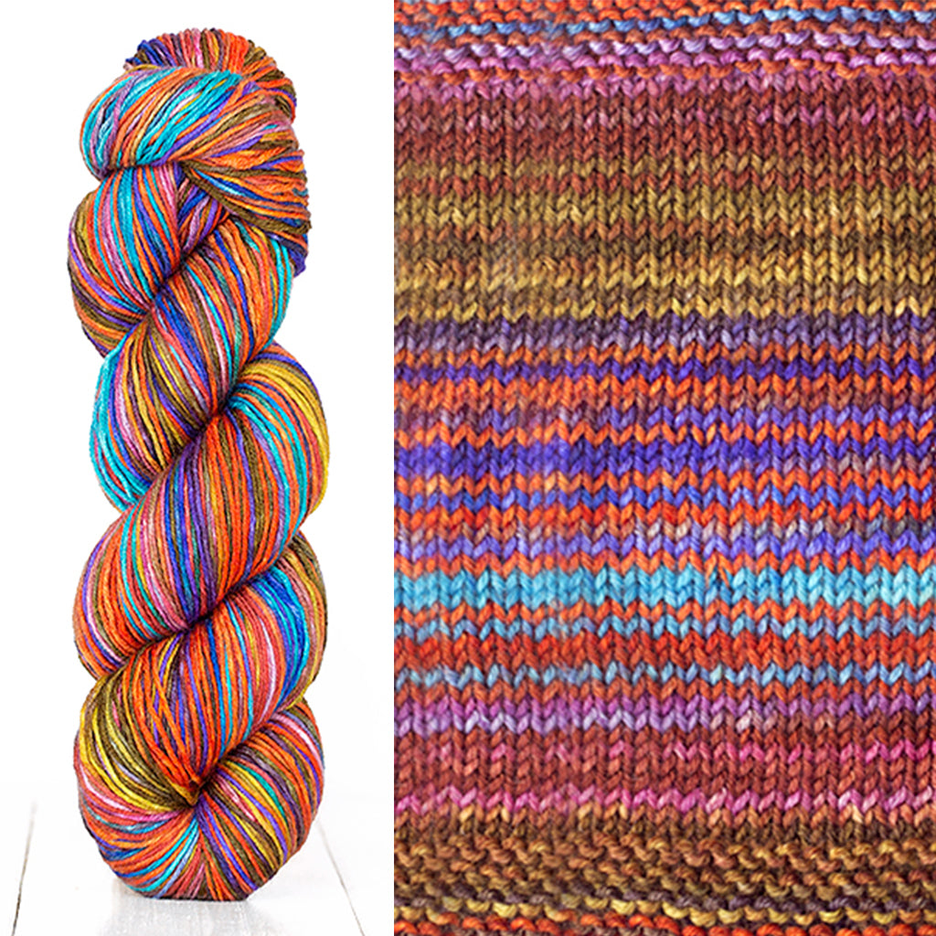 Color 3007: a hand-dyed skein of self striping wool yarn with brown, pink, blue, and yellow shades