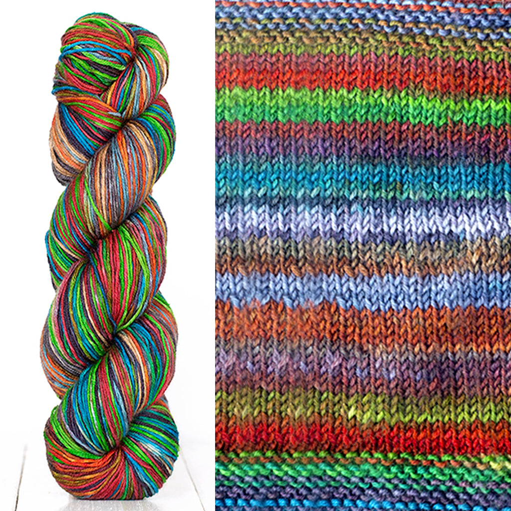 Color 3009: a hand-dyed skein of self striping wool yarn with blue, green, white, and orange shades