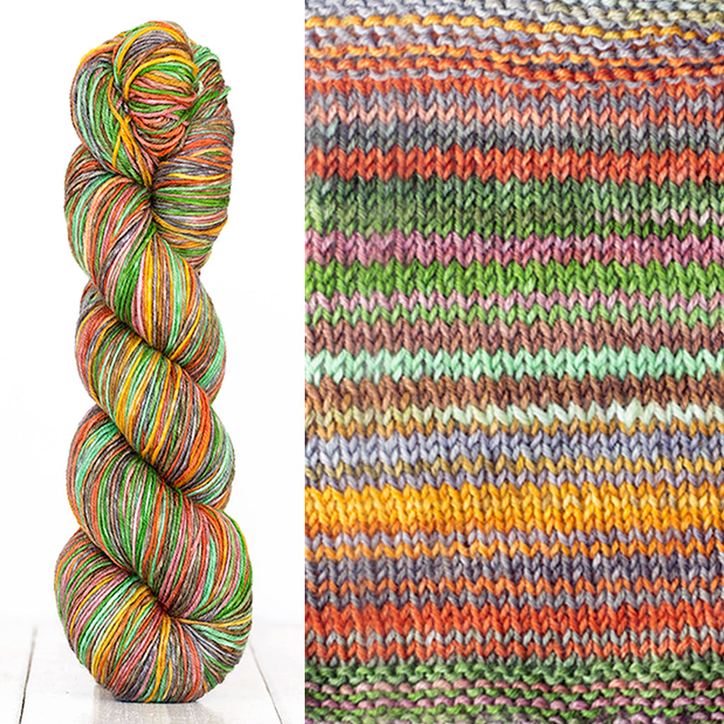 Color 3013: a hand-dyed skein of self striping wool yarn with green, red, yellow, and brown shades