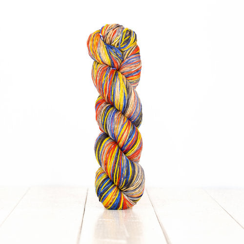 Color 3015: a hand-dyed self-striping wool yarn with yellow, red, blue, and grey stripes.
