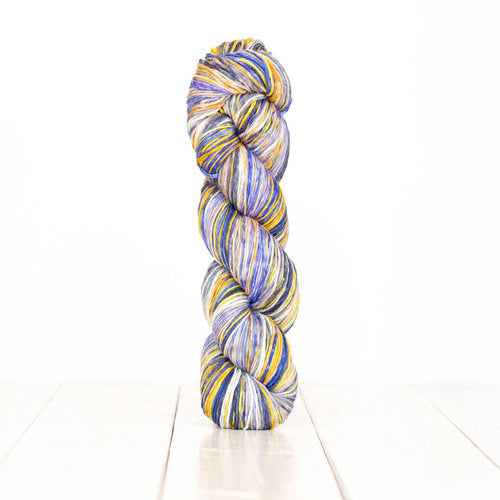Color 3016: a hand-dyed self-striping wool yarn with white, grey, tan, blue, and yellow stripes