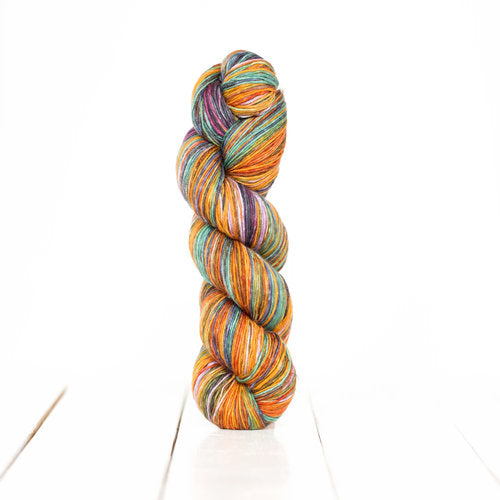 Color 3020: a hand-dyed self-striping wool yarn with purple, orange, blue, and tan stripes