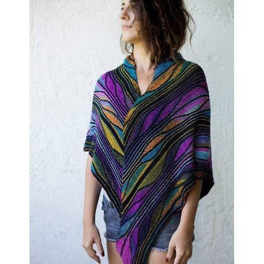 Model wearing the Butterfly Papillon Shawl Pattern in the shades purple, green, and blue.