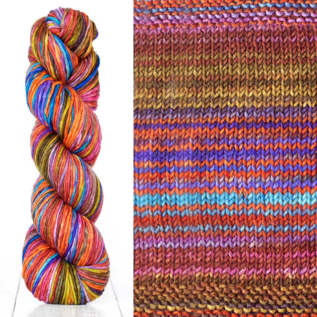 Color 4007: a hand-dyed skein of self striping wool yarn with brown, pink, blue, and yellow shades