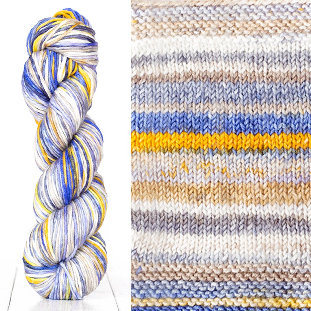 Color 4016: a hand-dyed skein of self striping wool yarn with white, grey, yellow, and blue shades.