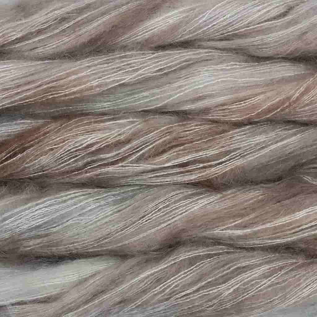 Color: Whole Grain 696. A taupe and soft pink color of Malabrigo Mohair yarn