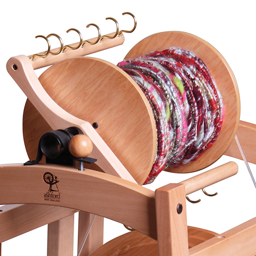 Ashford country e-spinner bobbin full of art yarn.