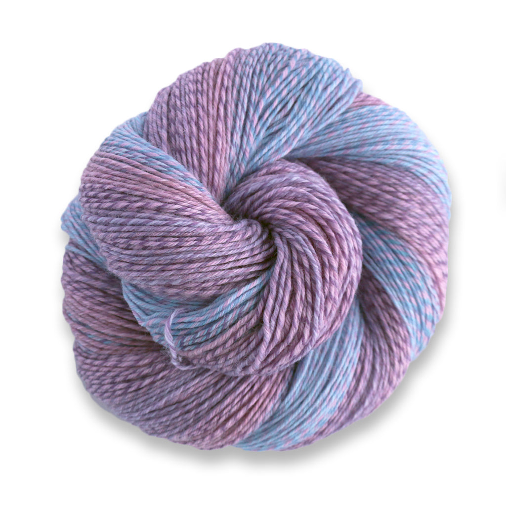 Heritage Wave in the color Dried Flowers 516, a marled pastel blue, purple, and pink sock yarn