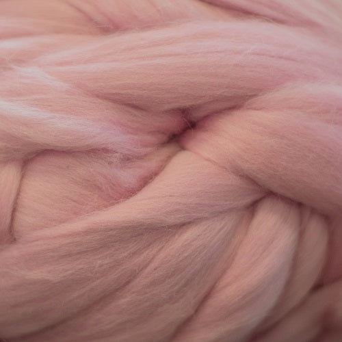 Color Pink. A light pink shade of solid color merino wool top.