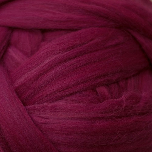 Color Ruby. A medium dark red purple shade of solid color merino wool top.