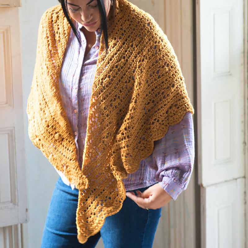 The Cressida Shawl wrapped around a woman's shoulders.