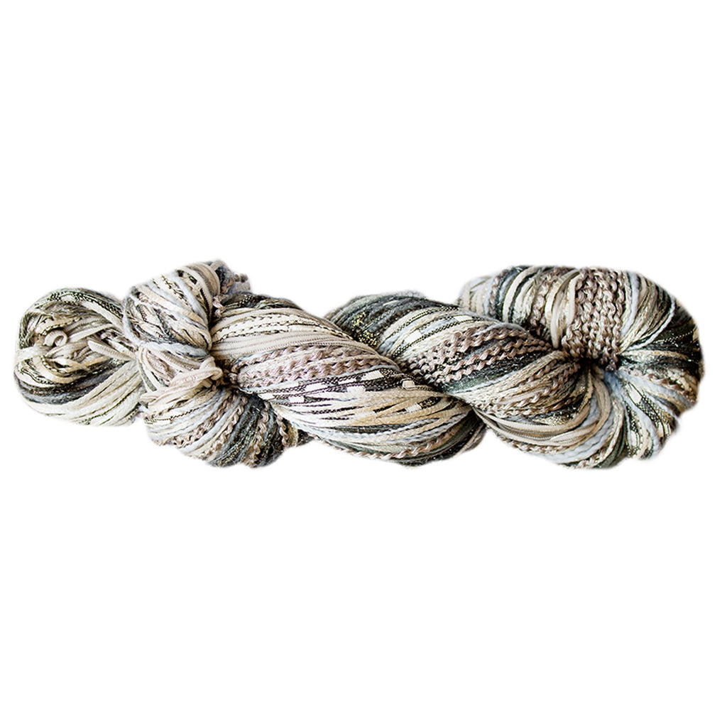 Color 514, a skein of light neutral colored yarn, full of texture and sparkle.