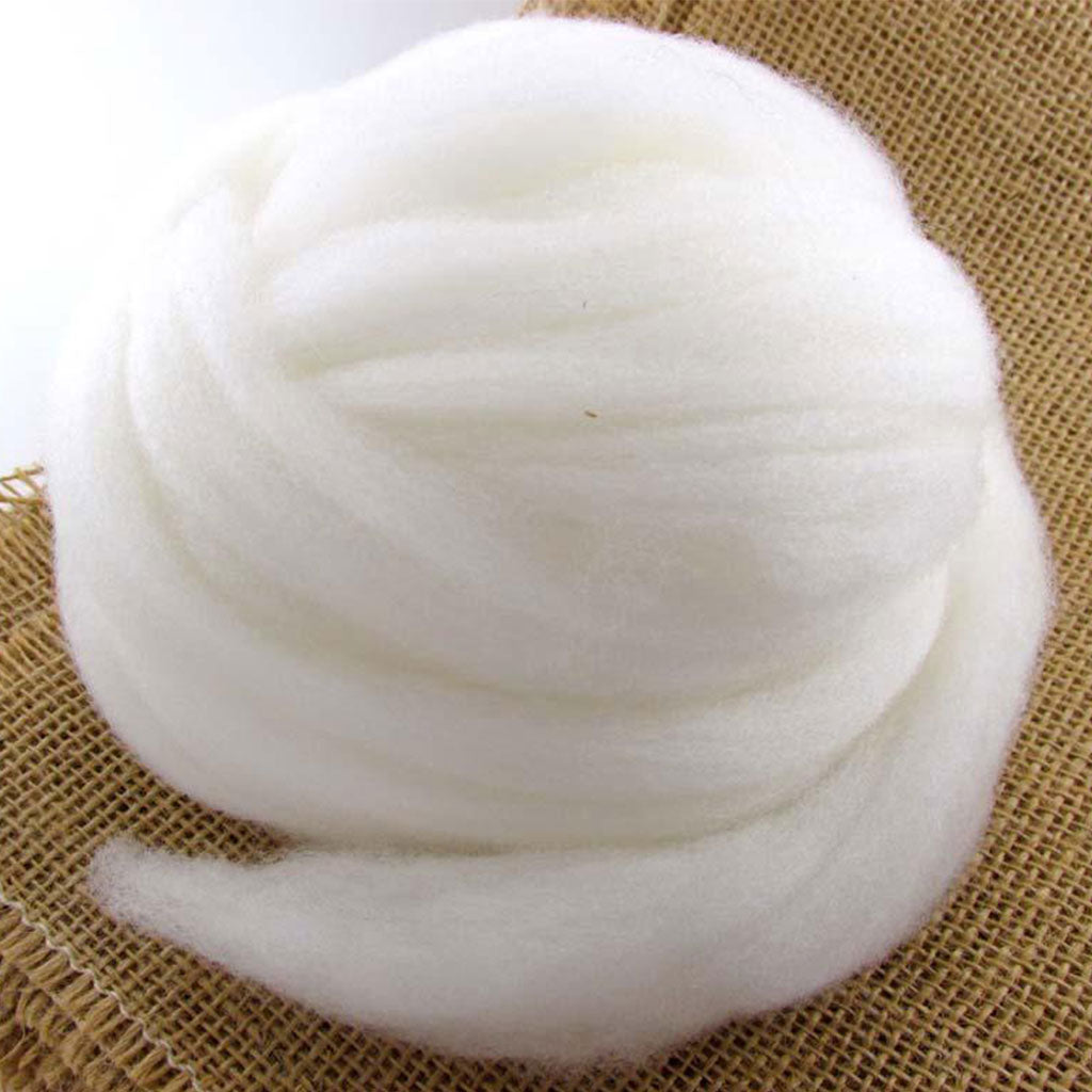 A ball of undyed, naturally white, cormo wool top.