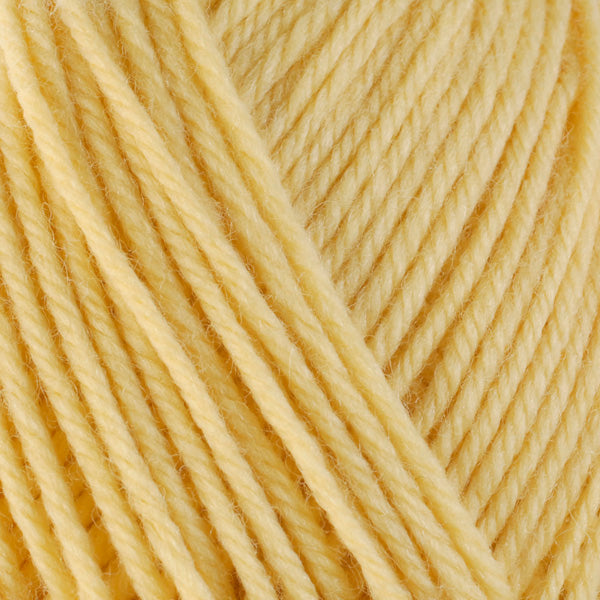 Butter 3312, a soft yellow skein of washable worsted weight Ultra Wool yarn.