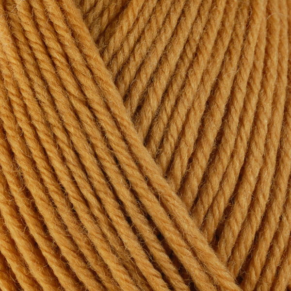 Butternut 3329, a cozy golden skein of washable worsted weight Ultra Wool yarn.