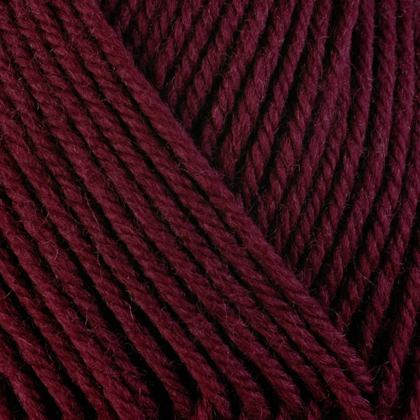 Currant 3360, a rich dark wine red skein of washable worsted weight Ultra Wool yarn.