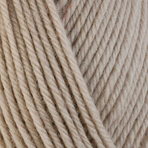 Oat 3305, a very light tan skein of washable worsted weight Ultra Wool yarn.