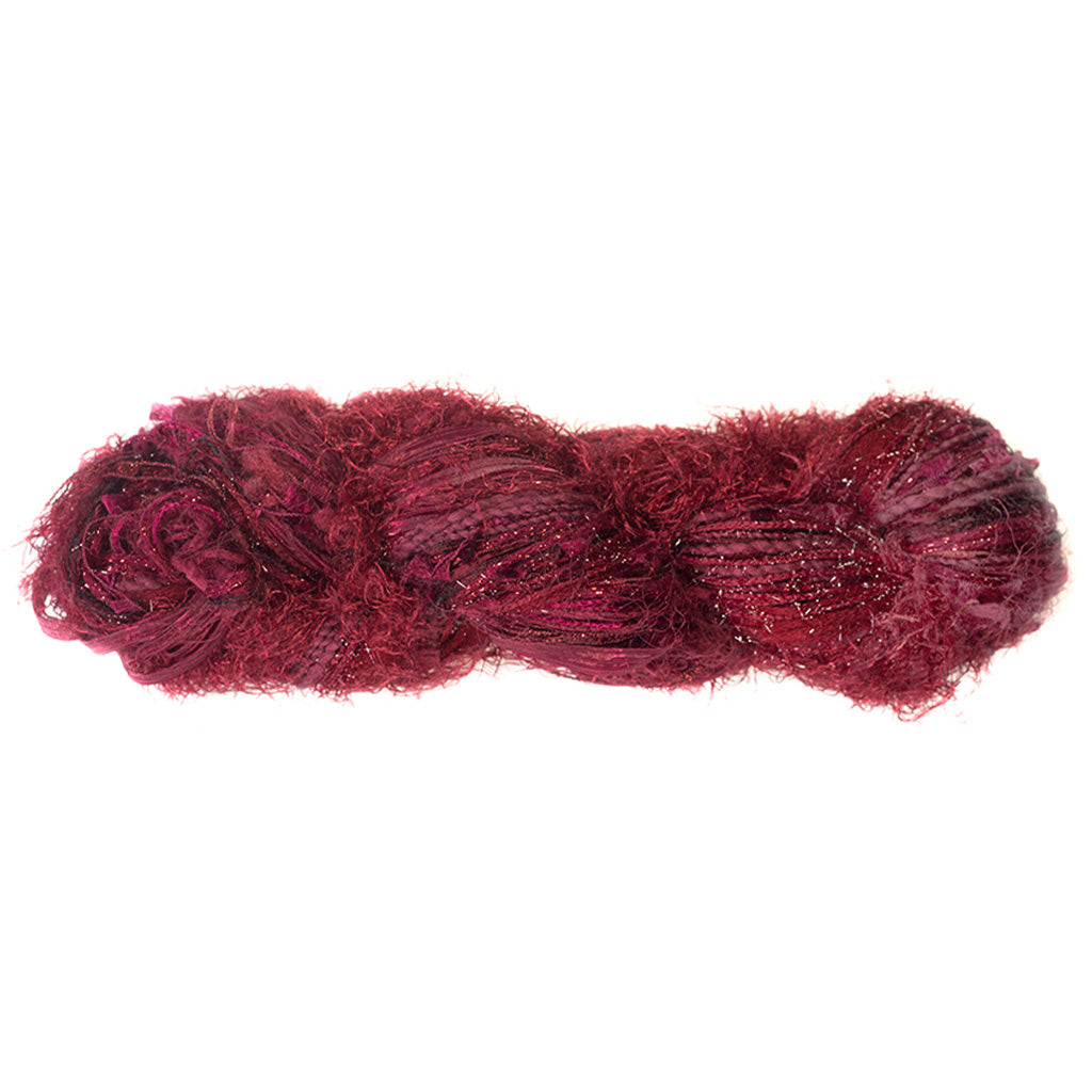 Color 513, a skein of burgundy yarn, full of texture and sparkle.