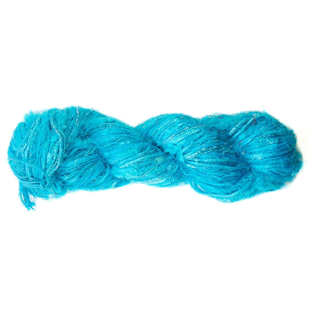 Color 516, a skein of bright cyan blue yarn, full of texture and sparkle.