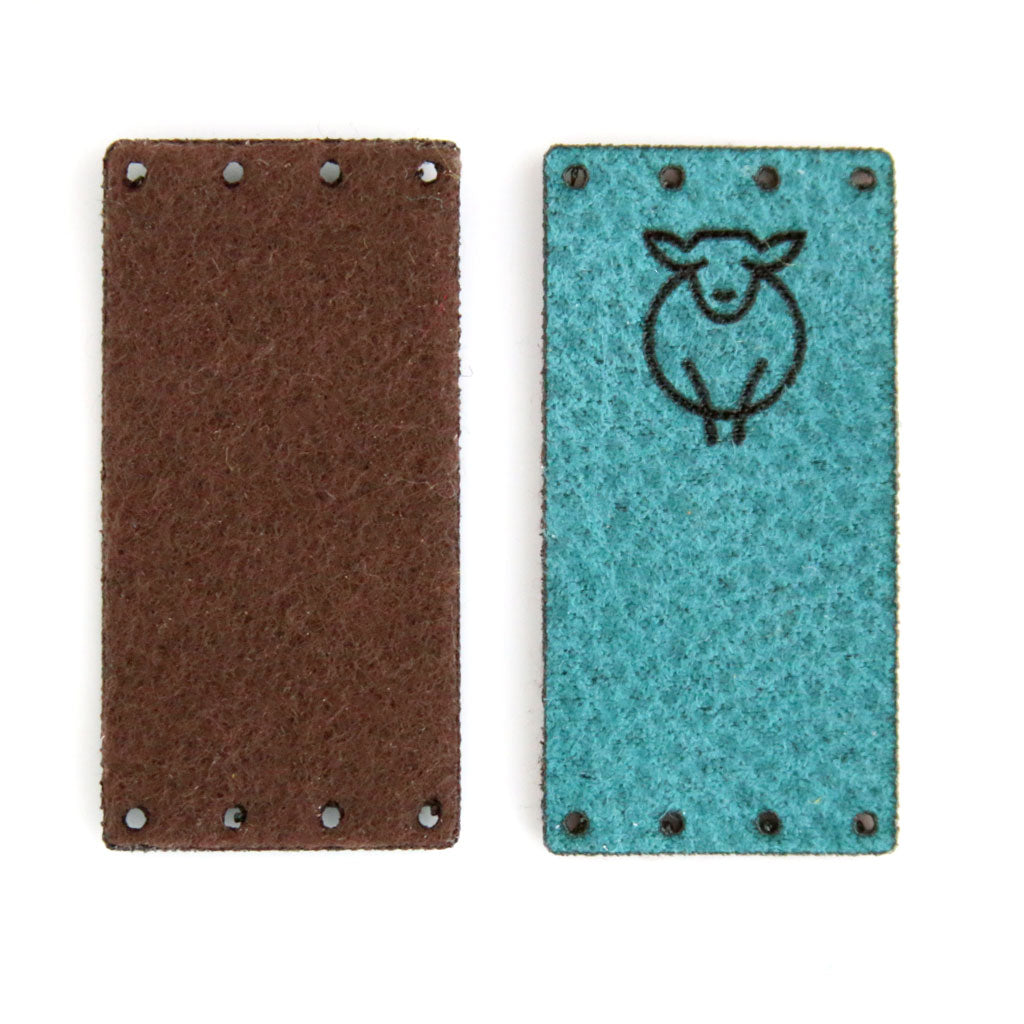 Color Turquoise with Brown backing, featuring a laser cut Paradise Fibers sheep logo.