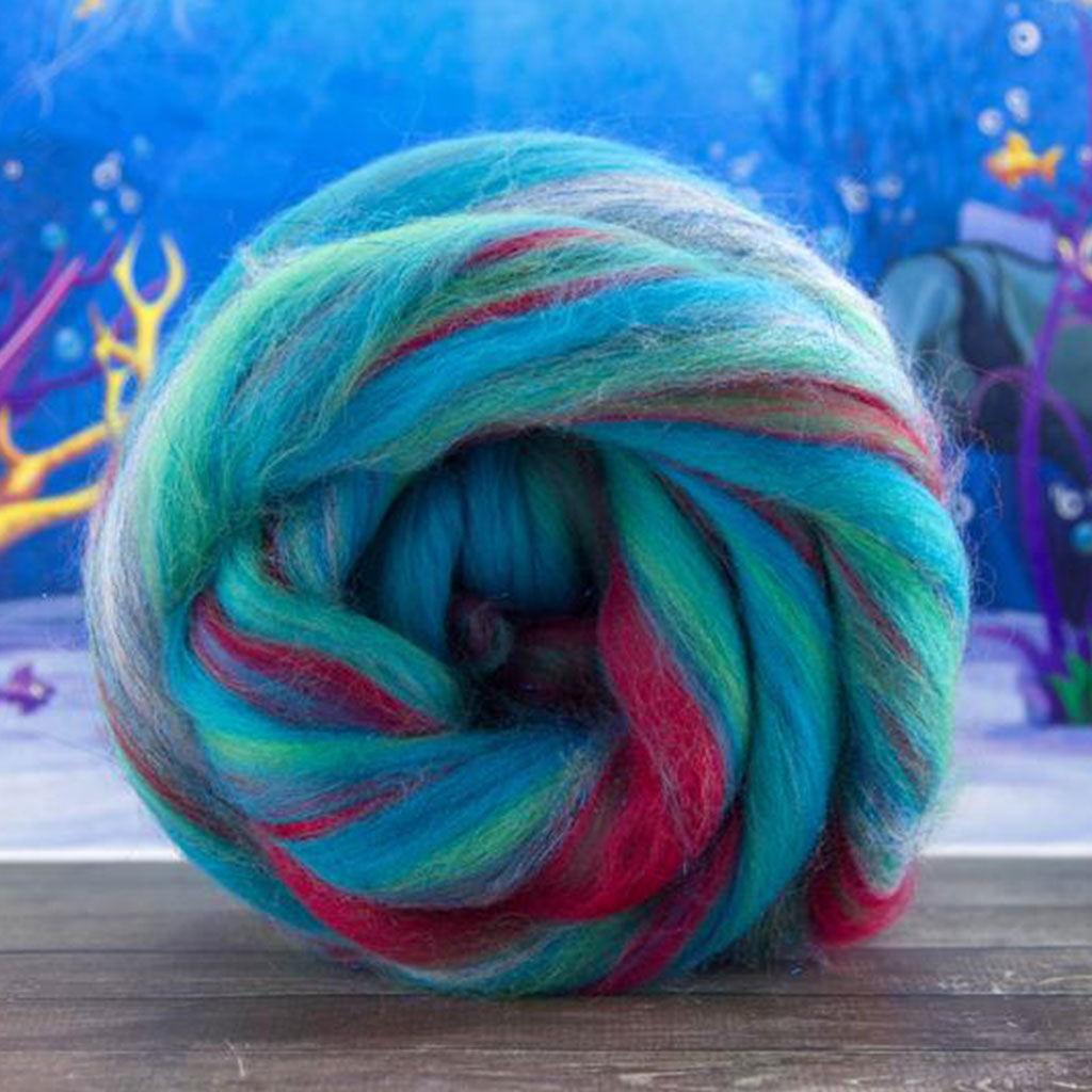 Color under the sea. An aqua blue and green with red blend of merino and stellina spinning fiber.