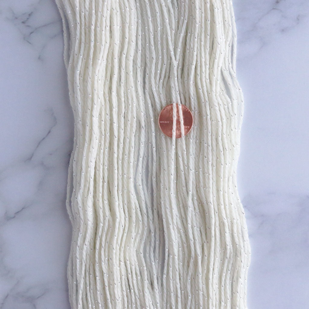 A close up of stardust, a superwash merino nylon with silver lurex sock yarn.