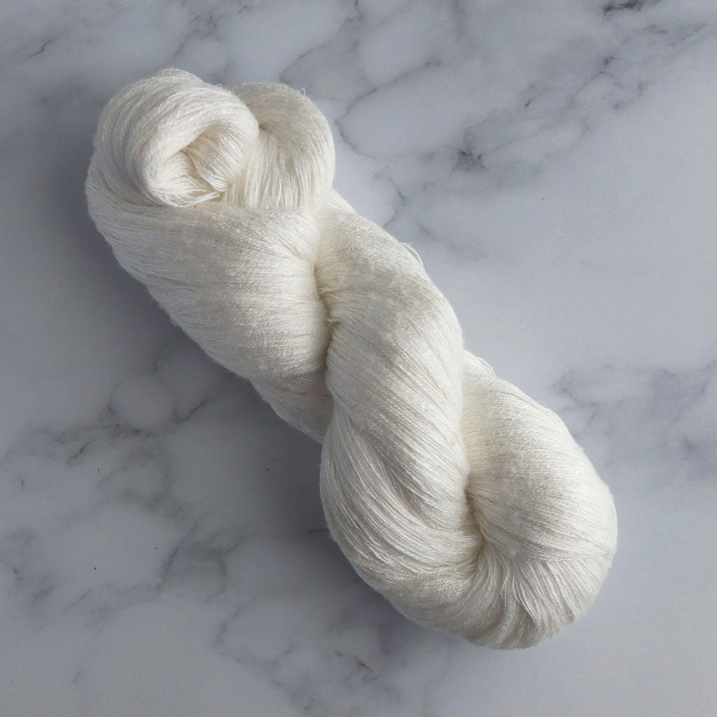 A skein of Paradise Fibers 28/2 Undyed Silk Throwster Yarn.