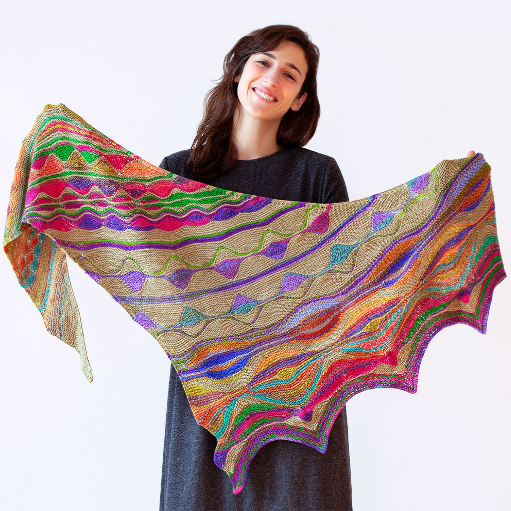 A model holding the Positive Vibrations Shawl