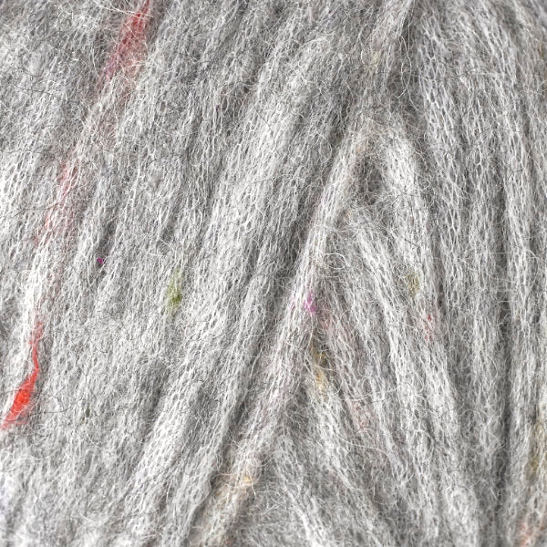 Color Black Sesame 3225. A dark grey speckled ball of Berroco Mochi yarn.