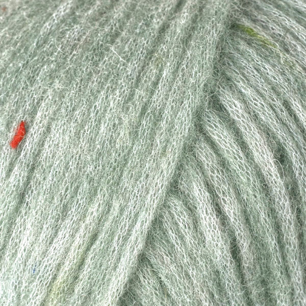 Color Green Tea 3208. A grey green speckled ball of Berroco Mochi yarn.