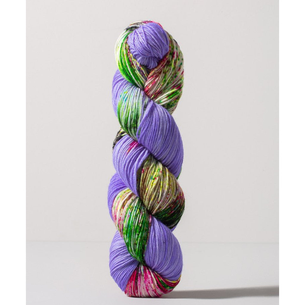 Gusto Carmen Fingering 1404 -periwinkle colorway with speckled leaf green, yellow, white and magenta