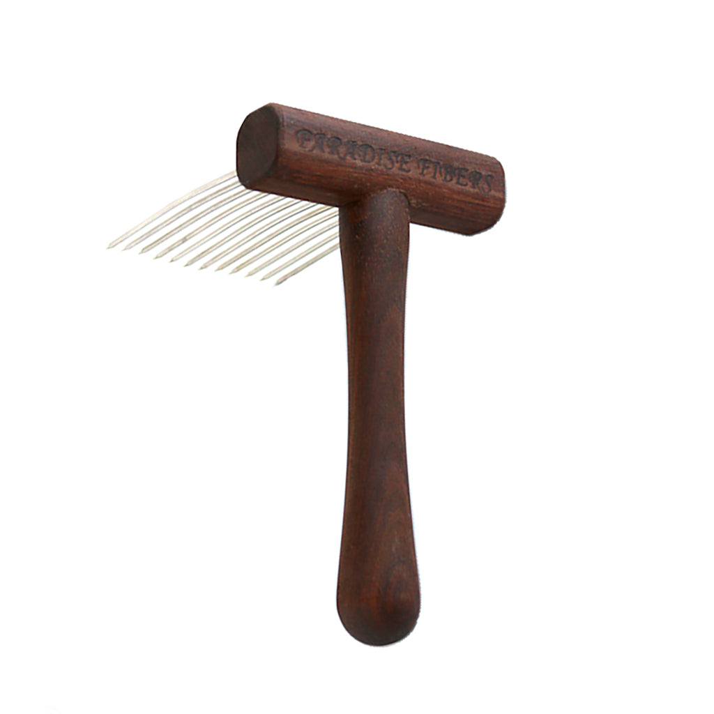 A single wool comb made of Walnut hardwood with Paradise Fibers burned on the handle.