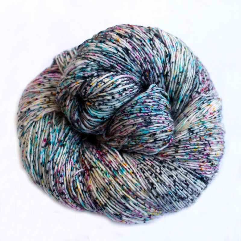 Malabrigo Mechita Double Bass - a speckled white, cyan, magenta and yellow colorway