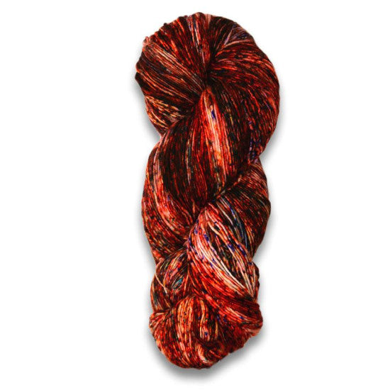 Malabrigo Mechita Lava Yarn - a speckled red-orange, white and black colorway