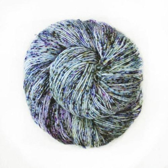 Malabrigo Mechita Passiflora Yarn - an ice blue yarn speckled with yellow, purple and blue