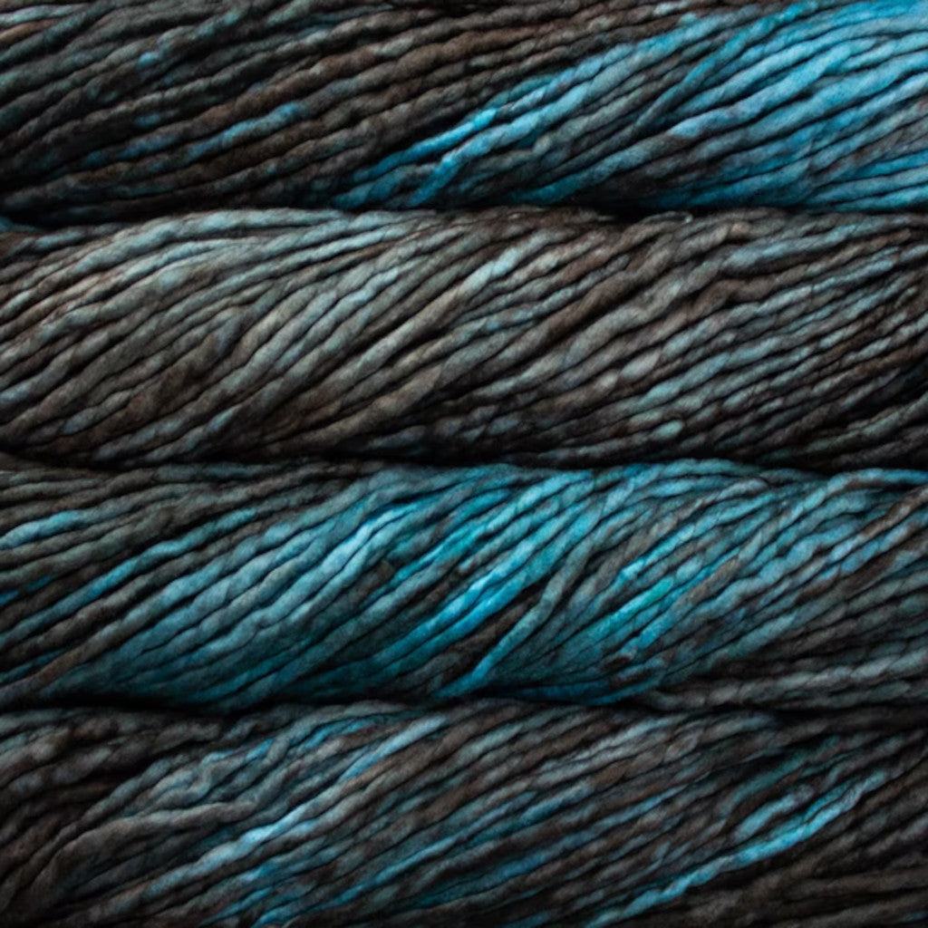 Color: Persia 852. A dark grey and teal variegated variant of Malabrigo Rasta yarn. 