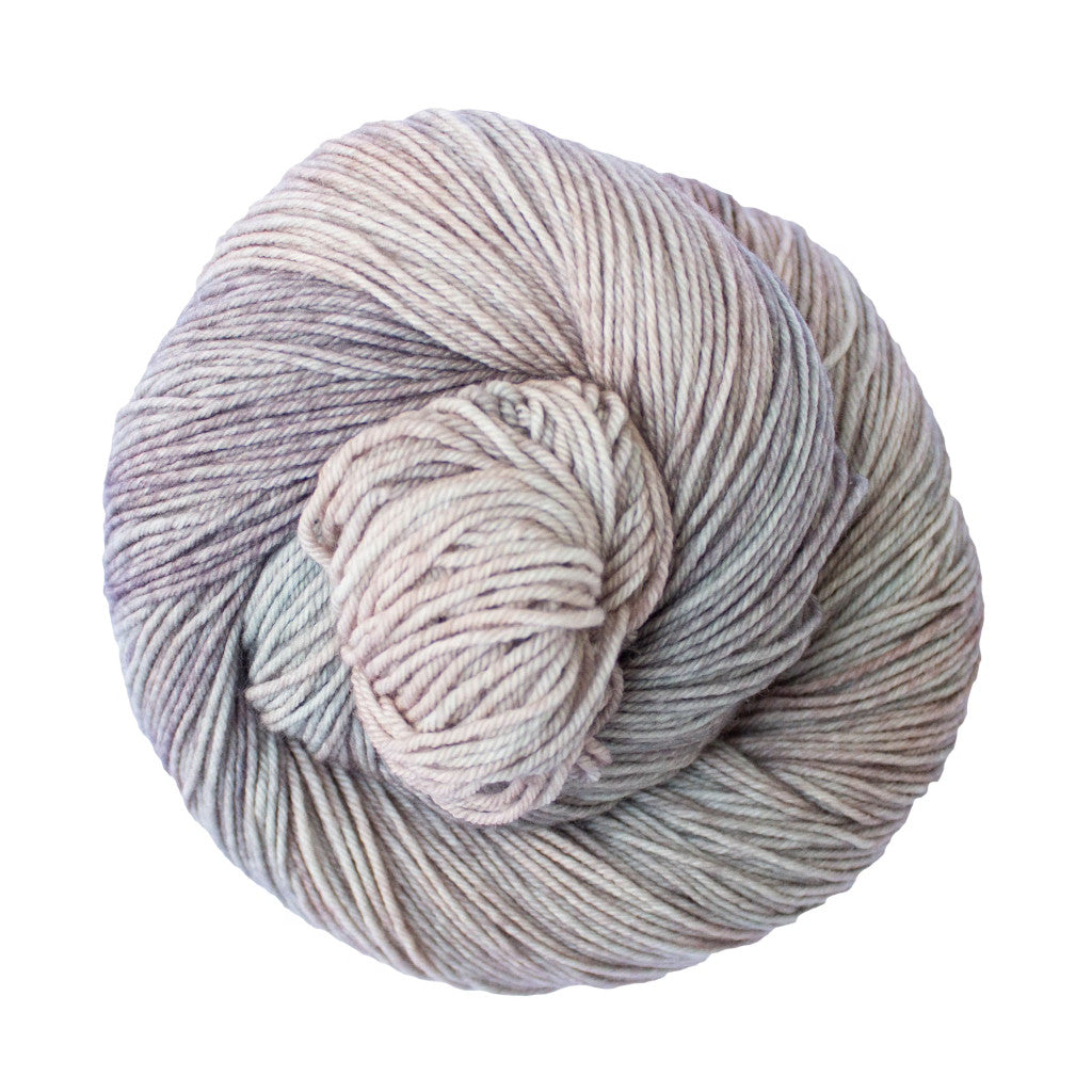 Color: Whole Grain 696. A tan, white, and pale pink variegated skein of Malabrigo Ultimate Sock yarn