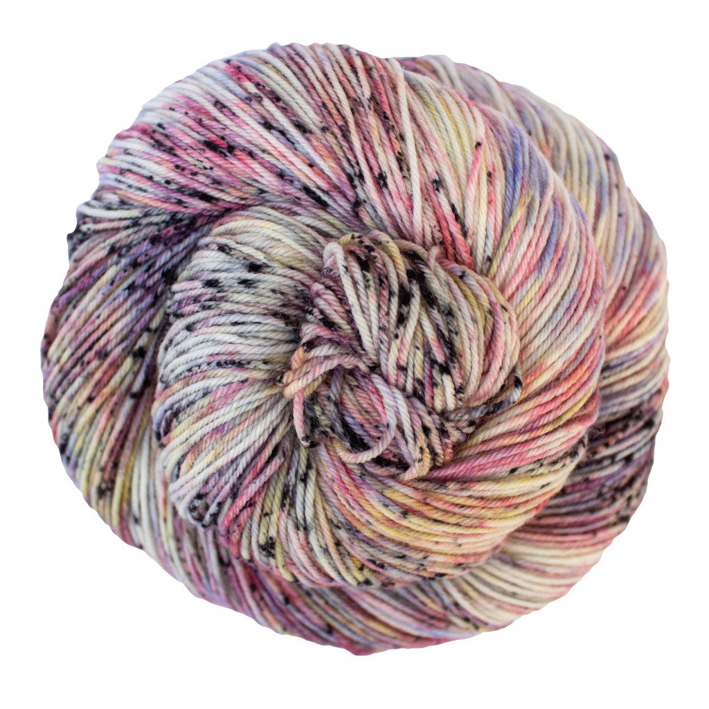 Color: Gloria 736. A white, pink, and purple speckled skein of Malabrigo Ultimate Sock yarn