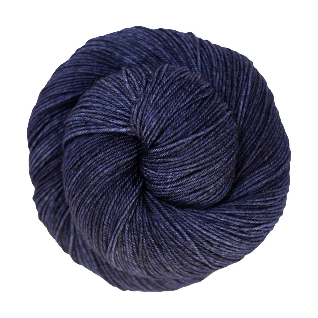 Color: Cote D' Azure 807. A very dark blue variegated skein of Malabrigo Ultimate Sock yarn