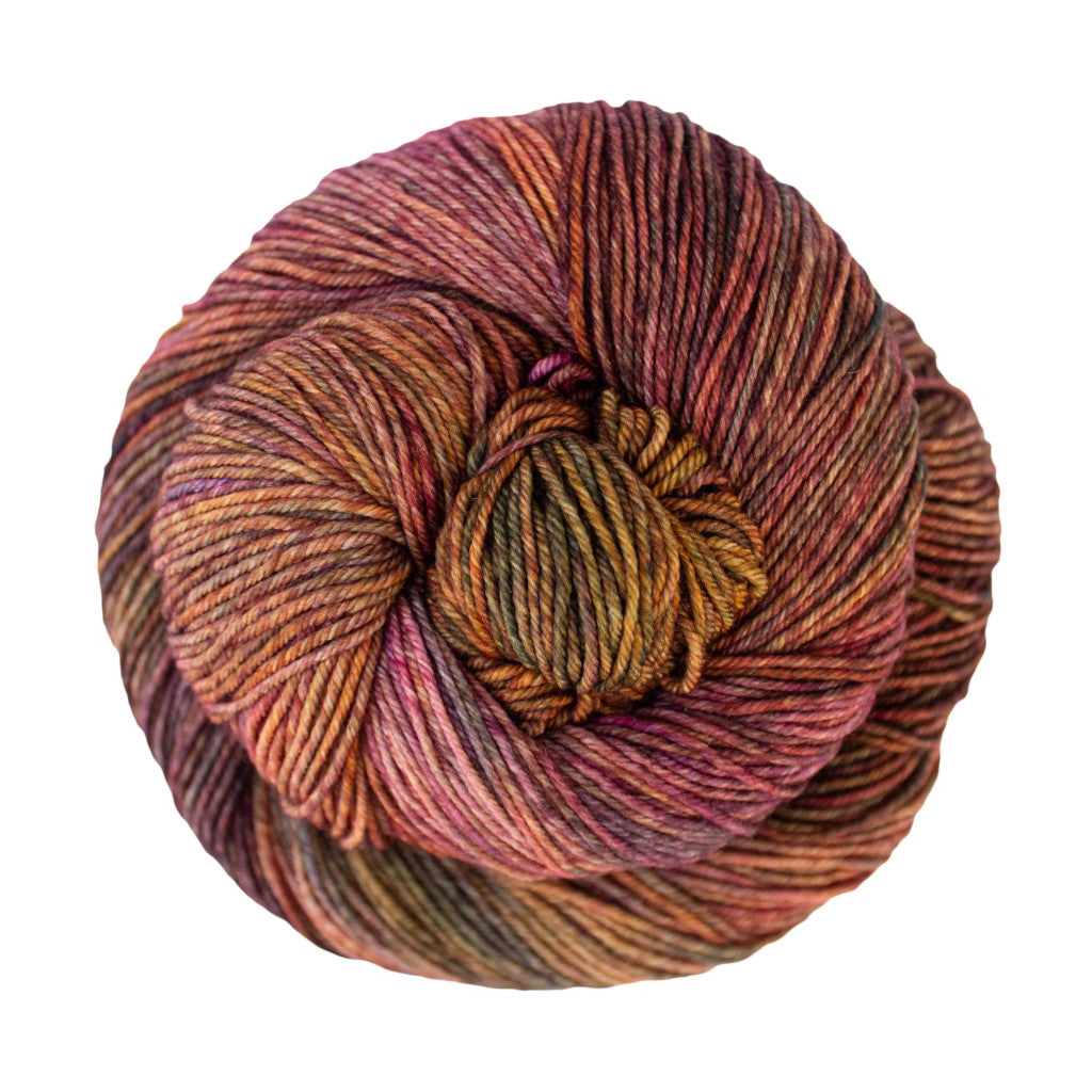 Color: Piedras 862. A gold, pink and green multi-colored skein of Malabrigo Ultimate Sock yarn