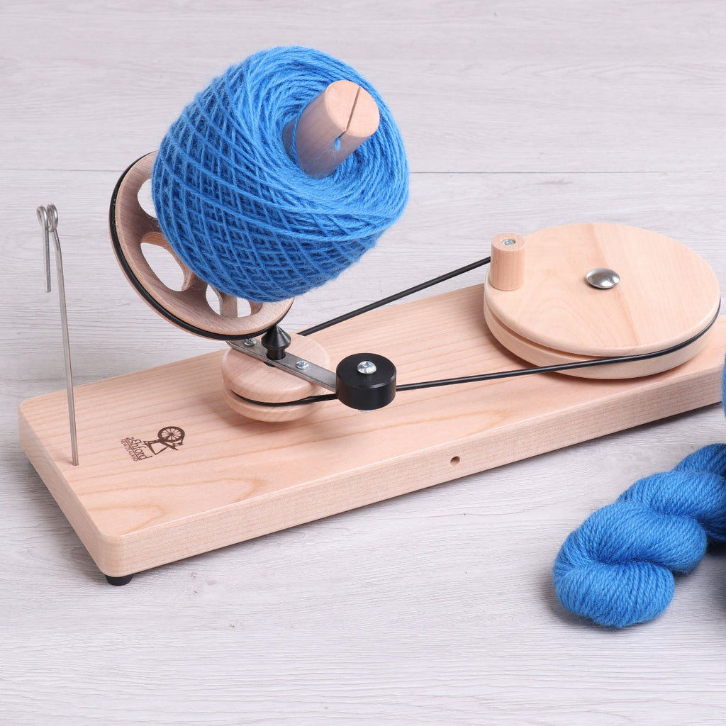 Ashford Ball Winder Fully Assembled with a blue skein of yarn on it. 