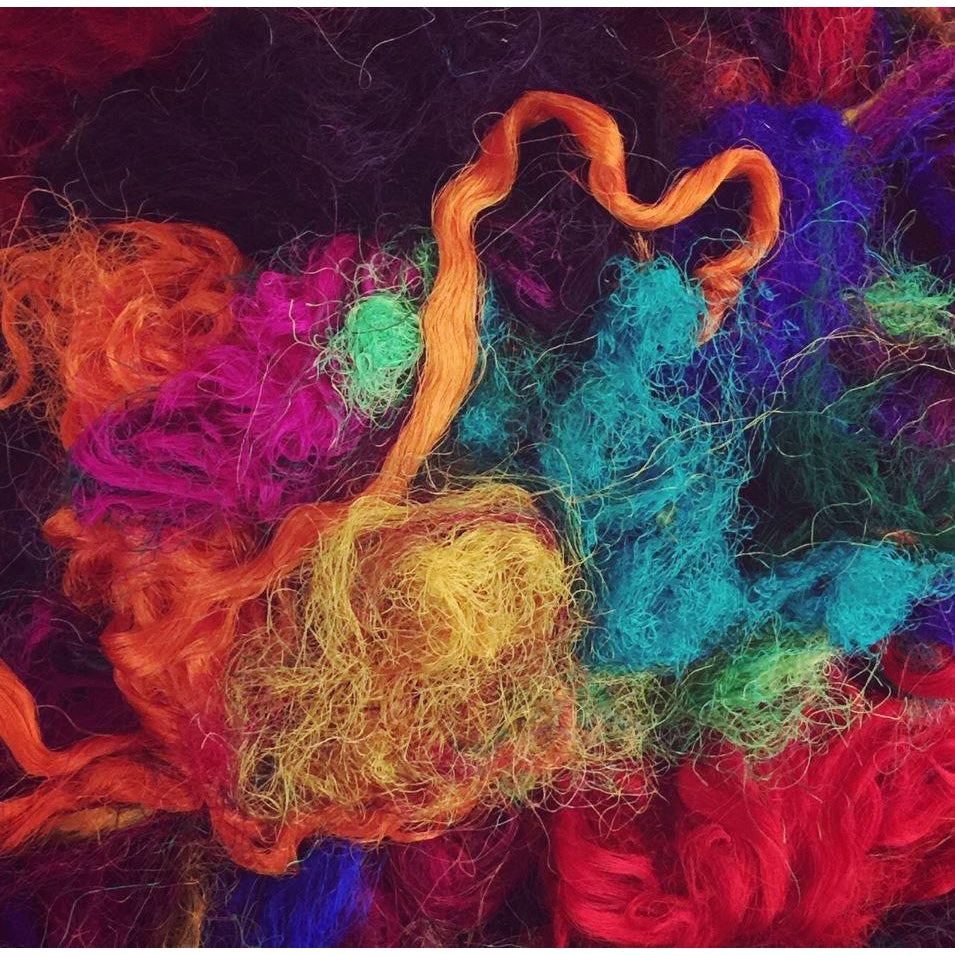 Multiple colors of recycled sari silk threads.