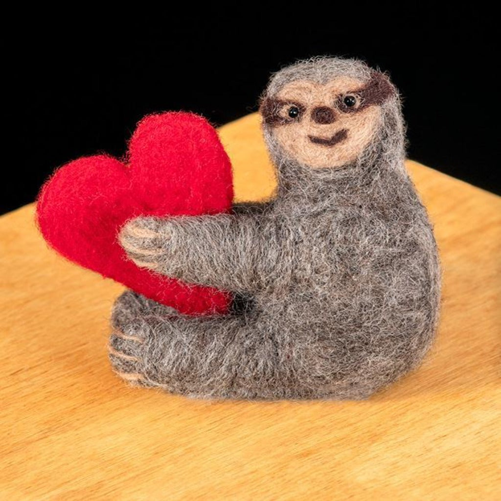 Woolpets sloth felting kit- a tan and brown sloth holding a red heart